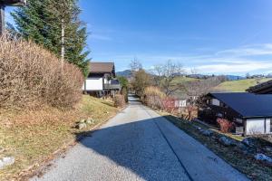 an empty road in a village with houses at Ferienhaus Vorauf - Rosenbauer in Siegsdorf