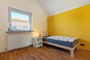 a bedroom with a bed and a window at Haus Kornfeld in Kehl am Rhein