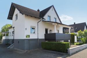 a white house with a brown roof at Haus Kornfeld in Kehl am Rhein