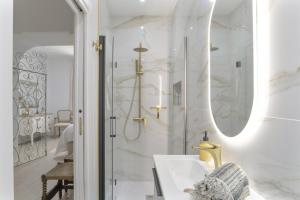 a white bathroom with a sink and a shower at Barsanz Palace Home in Alcalá del Valle +149 photos