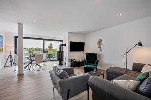 a living room with a couch and chairs and a table at Ferienbungalow Süssau in Süssau