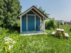 a blue dog house in a field of grass at Ferienhof Mrowka in Reutin