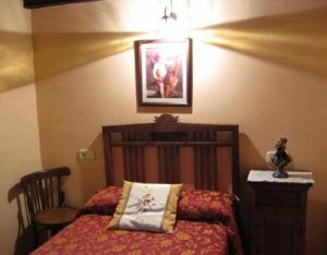 a bedroom with a bed and a picture on the wall at El Jermoso in Posada de Valdeón +14 photos