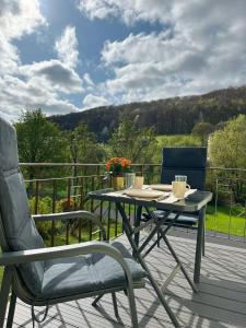 a table and two chairs sitting on a deck at Angernest in Elfershausen