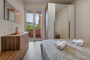 a bedroom with a bed with two pillows on it at My town home apartment in Torri del Benaco