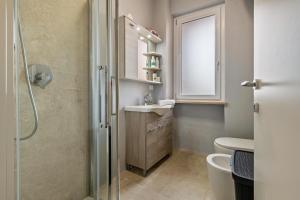 a bathroom with a shower and a sink and a mirror at My town home apartment in Torri del Benaco