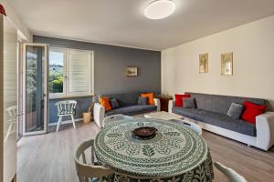 a living room with a table and a couch at My town home apartment in Torri del Benaco