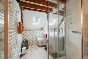 a bathroom with a glass shower and a toilet at Maison Plage Verger Cancale in Cancale +37 photos