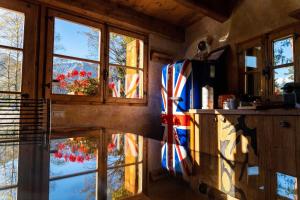 a room with windows and a flag on the wall at Chalet Armonia Res Albert in San Guglielmo