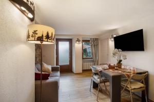 a living room with a table and a dining room at Agriturismo La Grange in Pont-Saint-Martin