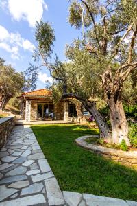a stone walkway in front of a house at Menagia Village in Agios Georgios