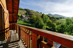 a balcony of a cabin with a view of the mountains at Appartement n°10 - 8 personnes in Saint-Sorlin-dʼArves