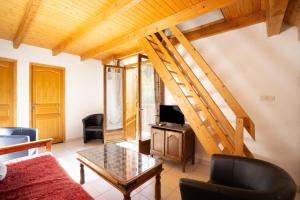 a living room with a couch and a table at Appartement n°10 - 8 personnes in Saint-Sorlin-dʼArves