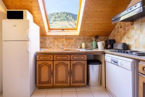 a kitchen with a sink and a white refrigerator at Appartement n°10 - 8 personnes in Saint-Sorlin-dʼArves