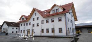 a large white building with a red roof at Ferienwohnung Josef in Gilching