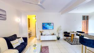 a living room with a couch and a table at Diani Hideouts 2 in Kwale