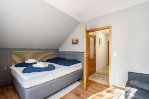 a bedroom with a bed with blue pillows at Ferienwohnung im Ländlichen Raum in Reuthen