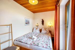 a bedroom with a bed with pink pillows at Ferienwohnung 3 in Grassau