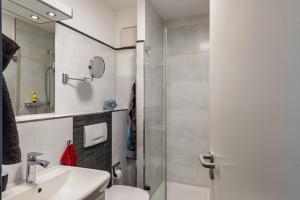 a bathroom with a toilet and a sink and a shower at Ferienwohnung Am Salzhaff B6 in Rerik +20 photos