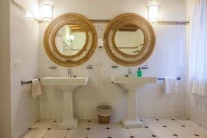 a bathroom with two sinks and two mirrors at Can Murenu in Sant Joan de Labritja +19 photos