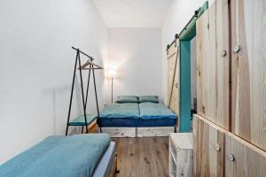 a bedroom with two beds and a mirror in it at Fichtel7 in Wunsiedel