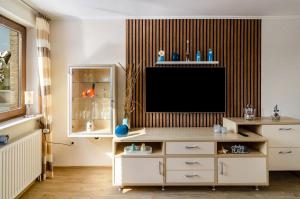 a living room with a flat screen tv on a wall at Ferienwohnung Bodenstein in Surwold