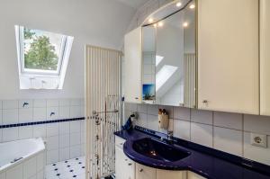 a bathroom with a sink and a mirror at Ferienwohnung Bodenstein in Surwold +24 photos