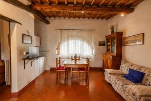 a living room with a table and a couch at Vallone di Cecione in Greve in Chianti +39 photos