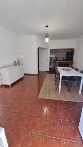 a living room with a table and a dining room at Retiro do Viajante in Penacova +10 photos