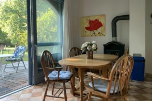 a dining room with a wooden table and chairs at Familienhaus in Trebel