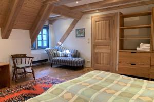 a bedroom with a bed and a chair at Familienhaus in Trebel