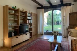 a living room with a tv and book shelves at Familienhaus in Trebel