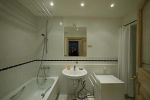 a bathroom with a sink and a bath tub and a sink at Familienhaus in Trebel +31 photos