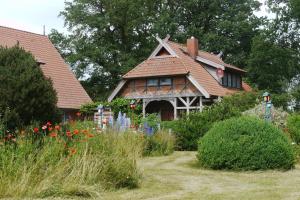 a house with a flower garden in front of it at Familienhaus in Trebel