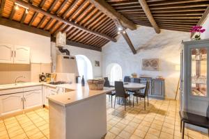a kitchen with a table and chairs in a room at Maison de Campagne in Gignac