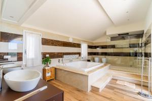 a large bathroom with a tub and a sink at Casa Vacanze Le Giuggiole in Spongano +25 photos