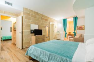 a bedroom with a bed and a flat screen tv at Casa Vacanze Le Giuggiole in Spongano