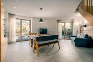 a living room with a table and a couch at Untermoarhof Albeins in Bressanone