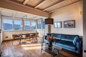 a living room with a couch and a table at Kraidlhof Designapartment Isabel in Cortaccia
