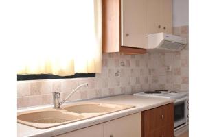 a kitchen with a sink and a stove at Manolika Studio 4 in Kithnos