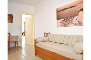 a living room with a couch and a table at Manolika Studio 4 in Kithnos
