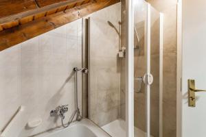a bathroom with a shower and a bath tub at Ferienwohnung Rinke in Schmallenberg +17 photos