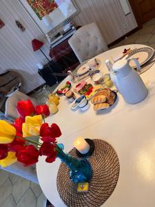 a table with flowers and plates of food on it at Chez Tantine Nadine in Couvin