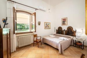 a bedroom with two beds and a window at Tenuta Il Carretto in Monteroni di Lecce +31 photos