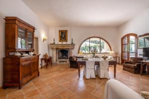 a living room with a table and a fireplace at Tenuta Il Carretto in Monteroni di Lecce