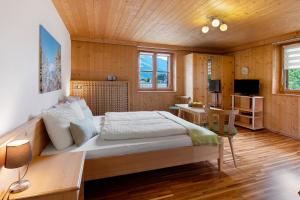 a bedroom with a large bed and a desk at Bauernhof Sackgut in Ciardes