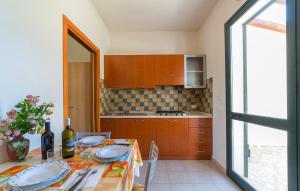 a kitchen with a table with plates on it at Lilybeo Village - Camping & Residence in Marsala