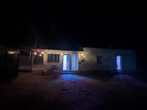 a dark room with a house at night at Gawkari Hillside Agroturism in Satara