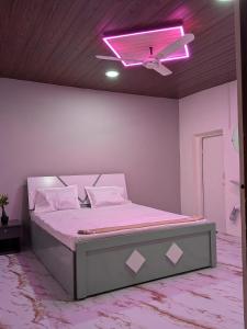 a bedroom with a bed with a pink ceiling at Gawkari Hillside Agroturism in Satara