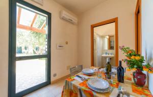 a dining room with a table and a window at Lilybeo Village - Camping & Residence in Marsala